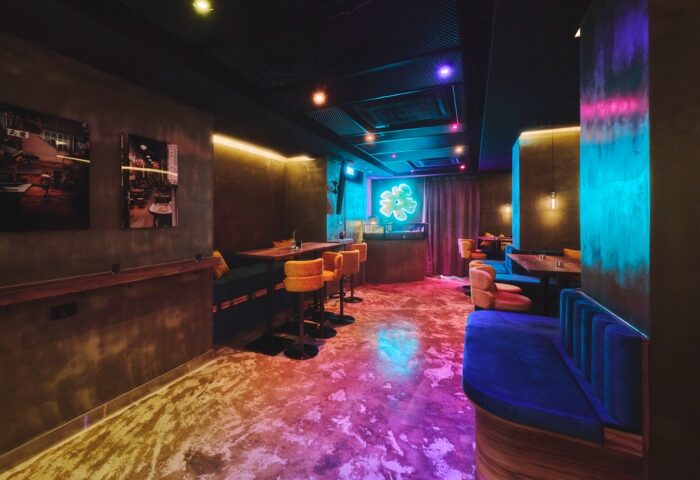 Fa Gai Hong Kong, a romantic gay bar. Interior view with neon flower, bar stools, and colorful lighting. Drag show & live DJ venue.