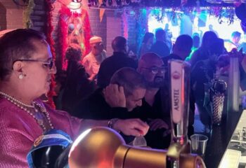 Inside Moulin Rose Gay Club in Sitges, Spain. People at the bar, enjoying the nightlife. Gay travel advice.
