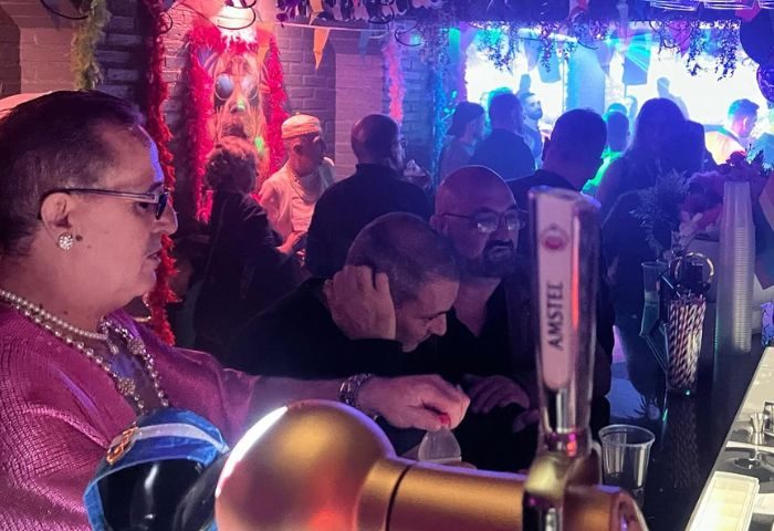 Inside Moulin Rose Gay Club in Sitges, Spain. People at the bar, enjoying the nightlife. Gay travel advice.