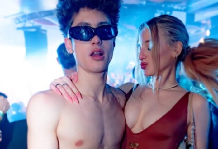 Muccassassina Rome: A shirtless man wearing sunglasses poses with a woman at Rome's famous gay-friendly party. Nightlife travel.