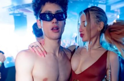 Muccassassina Rome: A shirtless man wearing sunglasses poses with a woman at Rome's famous gay-friendly party. Nightlife travel.