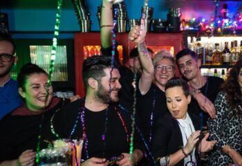Myrovolos bar staff celebrating, gay travel destination. Group of happy people, bar scene, nightlife. Myravolos party, fun, and camaraderie.