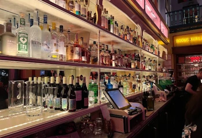 New York bar scene: Well-stocked shelves of liquor bottles at a bar in New York. Gay travel nightlife experience.