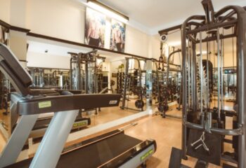 NaDam Spa Ho Chi Minh gym. Treadmill, weights, and fitness equipment in a modern, well-lit gym. Gay travel advice.