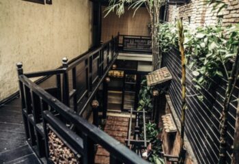 NaDam Spa, Ho Chi Minh. Interior view of the spa, with wooden walkways, plants, and traditional Vietnamese design elements. Gay travel advice.