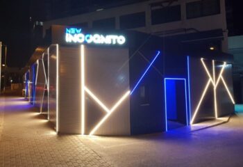 New Incognito Gay Bar in Benidorm. Illuminated exterior of a modern gay bar with geometric neon lights. Gay nightlife and travel.