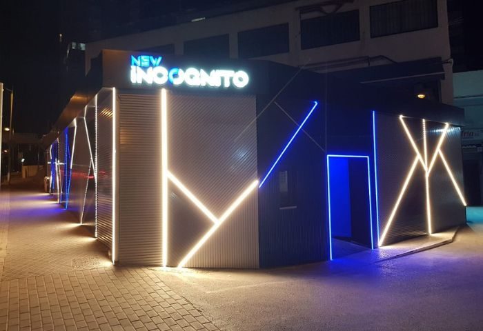 New Incognito Gay Bar in Benidorm. Illuminated exterior of a modern gay bar with geometric neon lights. Gay nightlife and travel.