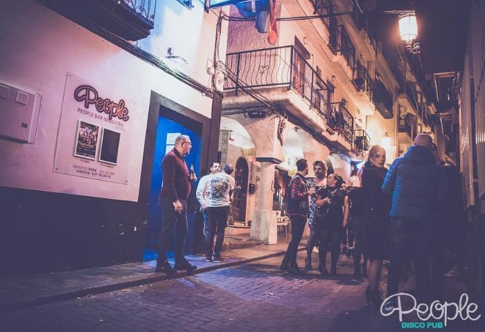People outside New People gay bar in Benidorm, Spain. A popular gay disco pub in Benidorm's old town for gay men's travel.