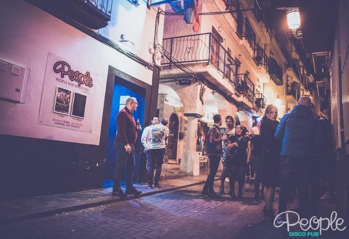 People outside New People gay bar in Benidorm, Spain. A popular gay disco pub in Benidorm's old town for gay men's travel.