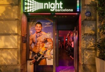 Night Barcelona gay cruise club entrance. Poster of a muscular man. Nightlife scene. Gay travel advice. Gay bar in Barcelona.