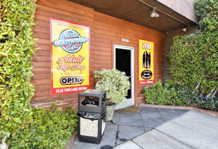 North Hollywood Spa entrance. Signage for adult gift shop, open hours, and 24hr service. A gay-friendly spa location.