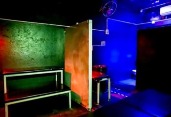 Noxon Club Gran Canaria interior. Gay cruise club with benches, partition, and blue lighting. Gay travel in Gran Canaria.