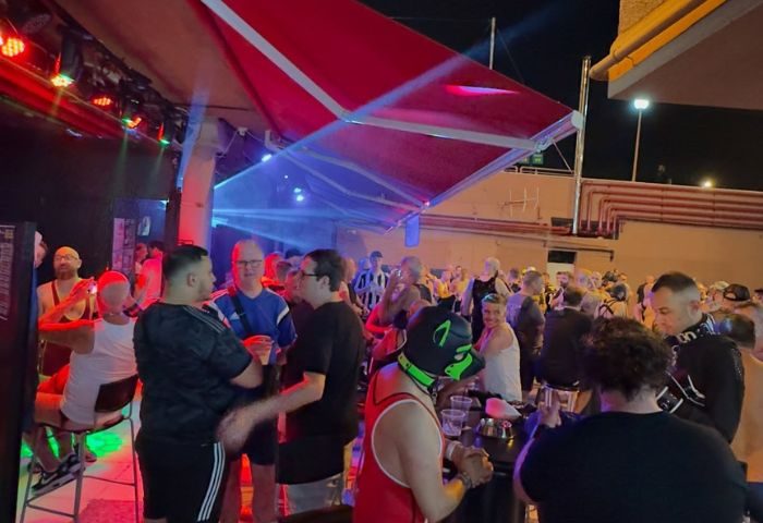 Noxon Terrace gay bar in Gran Canaria. A lively crowd of gay men enjoy the night at this popular gay bar. Nightlife scene.