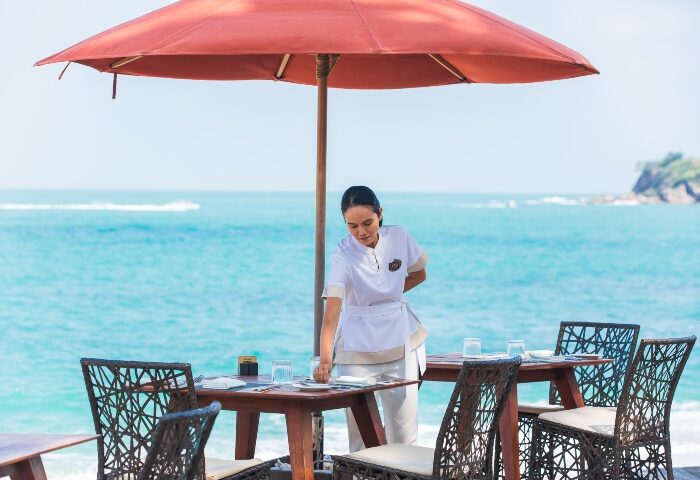 Garrya Tongsai Bay Samui: Waitress sets table at private beach pool villa. Gay hotel in Koh Samui offers luxury travel for gay men.