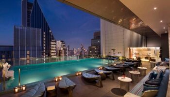 Hilton Sukhumvit Bangkok rooftop pool at night. A gay-friendly hotel in Sukhumvit area with skyline views, perfect for gay travelers in Thailand.