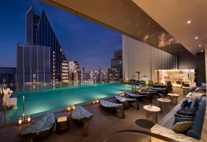 Hilton Sukhumvit Bangkok rooftop pool at night. A gay-friendly hotel in Sukhumvit area with skyline views, perfect for gay travelers in Thailand.