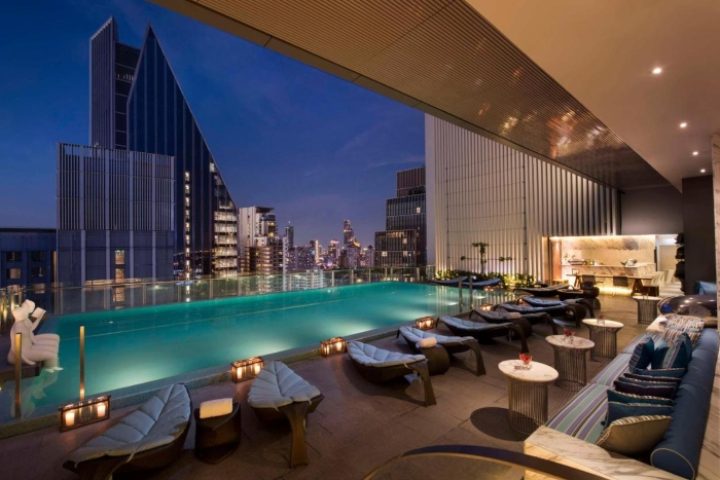 Hilton Sukhumvit Bangkok rooftop pool at night. A gay-friendly hotel in Sukhumvit area with skyline views, perfect for gay travelers in Thailand.