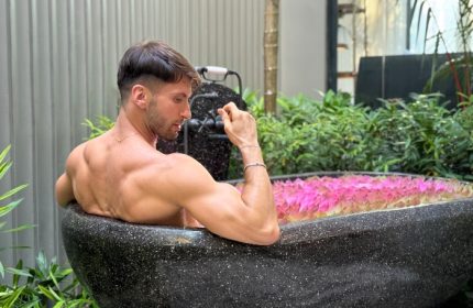 Gay man relaxing in a private pool villa at Shinta Mani Angkor. Bensley Collection Pool Villas in Siem Reap offer luxury travel for gay men.