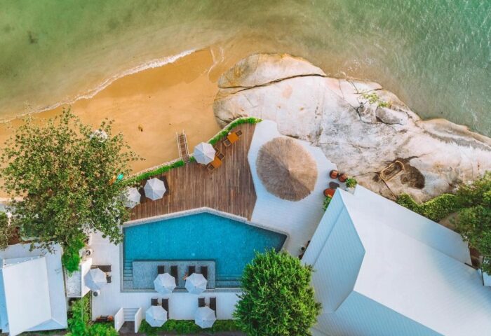 Rocky's Boutique Resort Veranda Collection Samui: Aerial view of beachfront gay resort with pool, beach, and rocks in Koh Samui.