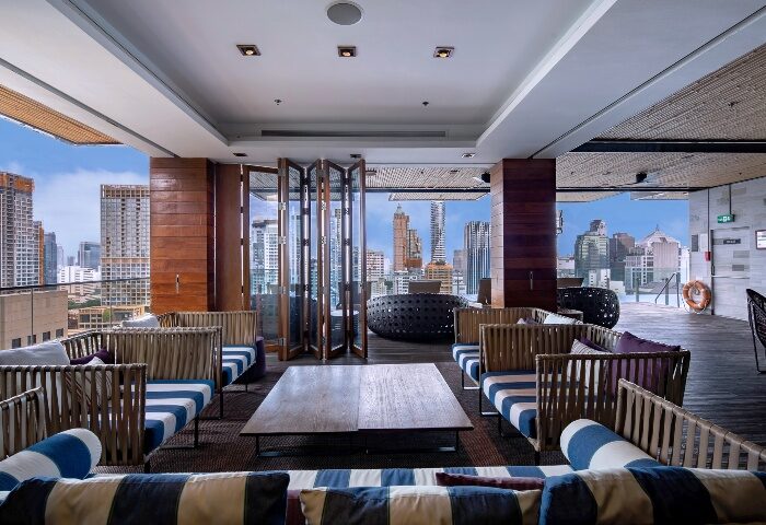 Hotel Indigo Bangkok Wireless Road rooftop bar. Gay-friendly hotel near gay bars. Bangkok skyline view from stylish lounge.