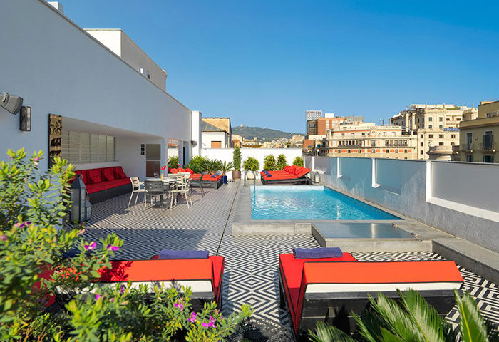 H10 Metropolitan Hotel outdoor pool in Barcelona's Eixample district. This gay-friendly hotel offers a rooftop terrace with city views.