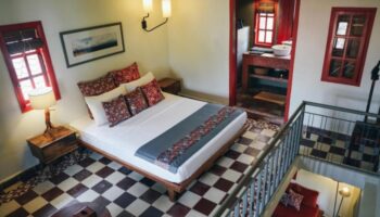 Rambutan Resort Siem Reap room. Gay hotel with bed, bathroom, and red accents. Number one gay hotels list update in Siem Reap, Cambodia.