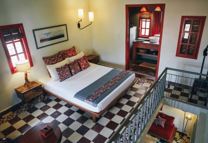 Rambutan Resort Siem Reap room. Gay hotel with bed, bathroom, and red accents. Number one gay hotels list update in Siem Reap, Cambodia.
