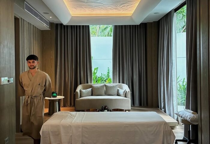 Gay man at InterContinental Phuket Resort's wellness spa. Beach resort offers massage, sofa, and relaxing ambiance for gay travel.