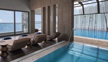 JW Marriott Hotel Istanbul Marmara Sea luxury wellness gay hotel pool and lounge chairs. Relaxing spa day for gay men travelers.