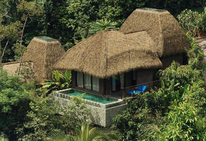 Keemala gay hotel Phuket: Unique design private pool villa. Lush greenery surrounds the thatched-roof villa, a tropical gay travel paradise.