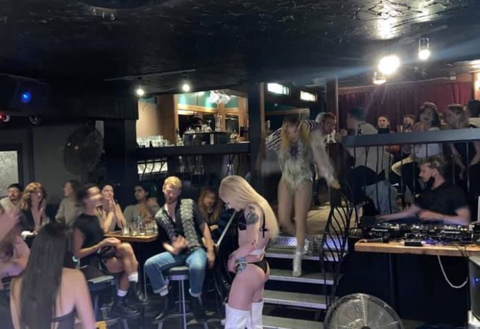 Nightlife at Numbers Cabaret in Vancouver. Drag queens perform on stage. DJ plays music for the audience. Gay travel advice.