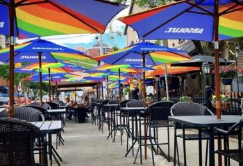 O'Grady's on Church Bar in Toronto. Outdoor patio seating with rainbow umbrellas. Gay bar known for its friendly atmosphere.