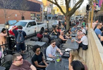 O'Grady's on Church bar in Toronto: Outdoor patio scene with diverse crowd enjoying drinks. Gay-friendly travel destination in Canada.