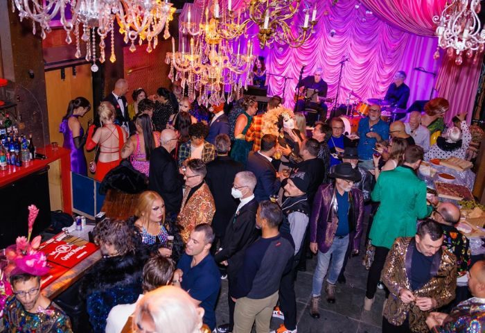 Oasis Drag Cabaret in San Francisco: A vibrant, crowded scene with drag queens, a live band, and patrons enjoying the lively atmosphere.