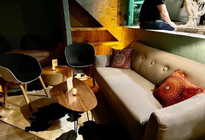 One Six One gay bar in Puerto Vallarta. Stylish lounge area with sofa, chairs, and tables. Cozy, intimate atmosphere for gay travelers.