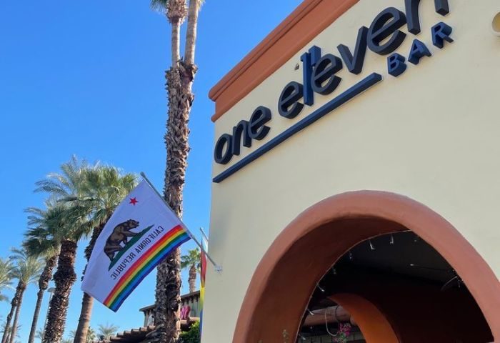 OneEleven Bar location. Gay bar in Palm Springs, CA. California state flag with rainbow LGBTQ+ pride colors. Gay travel destination.