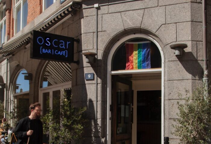 Oscar Bar Cafe in Copenhagen. Gay travel advice. Rainbow flag in window. LGBTQ+ friendly bar and cafe. Gay bar in Denmark.