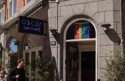 Oscar Bar Cafe in Copenhagen. Gay travel advice. Rainbow flag in window. LGBTQ+ friendly bar and cafe. Gay bar in Denmark.