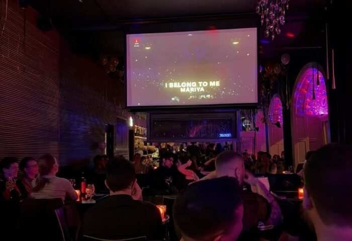 Oscar Bar Cafe Copenhagen: Gay bar patrons enjoy karaoke night. A fun gay nightlife spot for travel advice in Copenhagen.