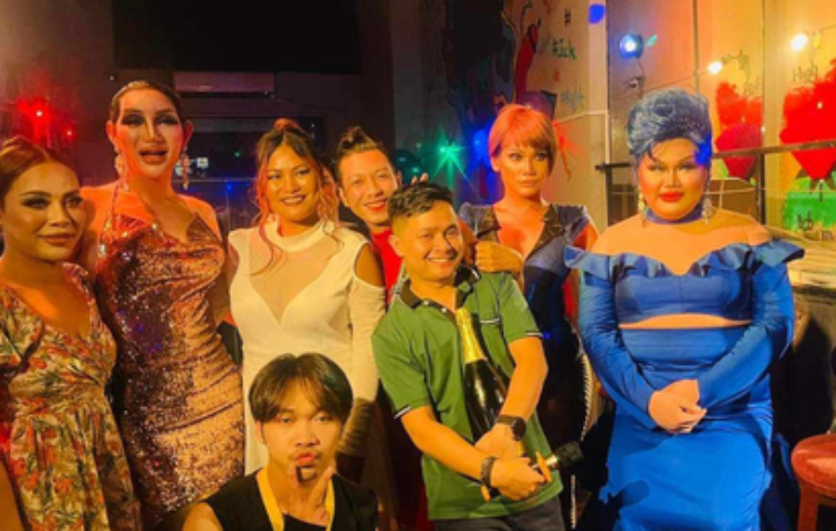 POC Bar Phnom Penh: Group photo inside a gay bar. Drag queens and patrons pose for a fun shot at this popular gay nightlife spot.