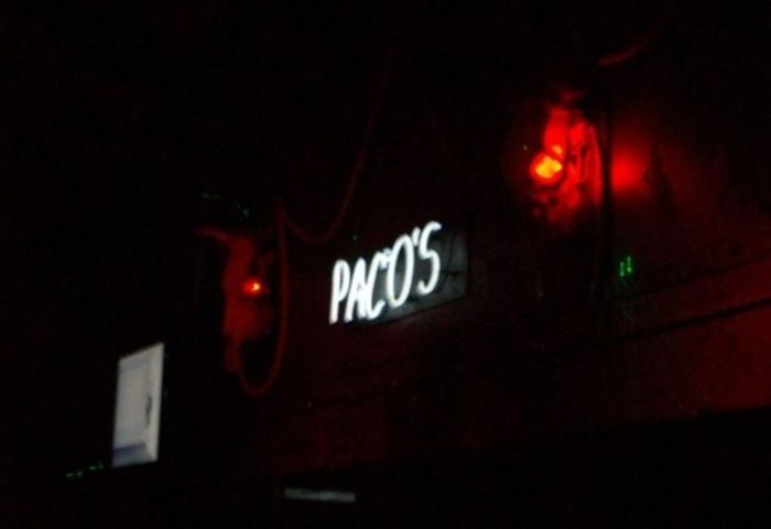 Paco's Ranch gay bar in Puerto Vallarta. Neon sign glows in the dark. Red lighting. Gay travel destination.
