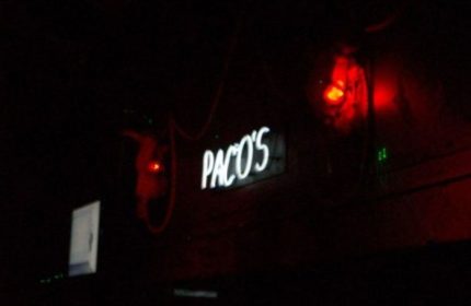 Paco's Ranch gay bar in Puerto Vallarta. Neon sign glows in the dark. Red lighting. Gay travel destination.