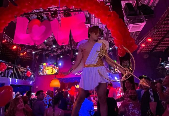Cupid at Paco's Ranch, a gay bar in Puerto Vallarta. The bar is decorated with balloons and a LOVE sign. Nightlife for gay men.