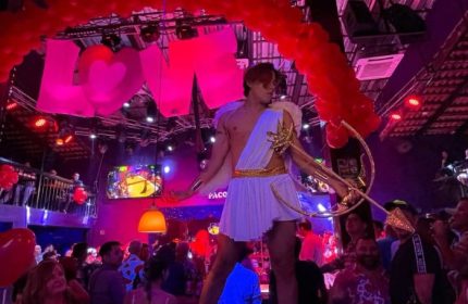 Cupid at Paco's Ranch, a gay bar in Puerto Vallarta. The bar is decorated with balloons and a LOVE sign. Nightlife for gay men.