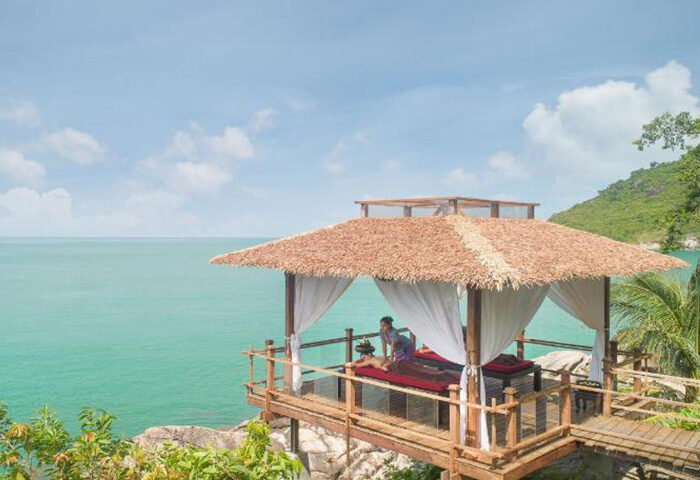 Panviman Resort Koh Phangan's luxury gay hotel. Perfect pool villas with ocean view. Man getting massage. Instagram travel for gay men.