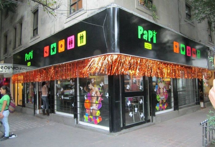 Papi Fun Bar gay party in Mexico. Exterior view of the bar with colorful signage and decorations. Gay travel advice.