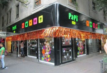 Papi Fun Bar gay party in Mexico. Exterior view of the bar with colorful signage and decorations. Gay travel advice.