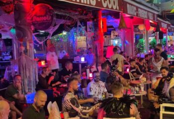 Parrots Pub Gran Canaria: Gay bar in Yumbo Centre, Maspalomas. Men in costumes, Halloween decorations, and a lively atmosphere.