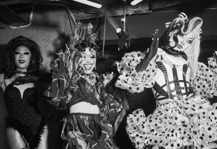 Peach Hanoi drag show: Three drag queens in elaborate costumes pose for a photo. Hanoi's nightlife offers unique gay travel experiences.