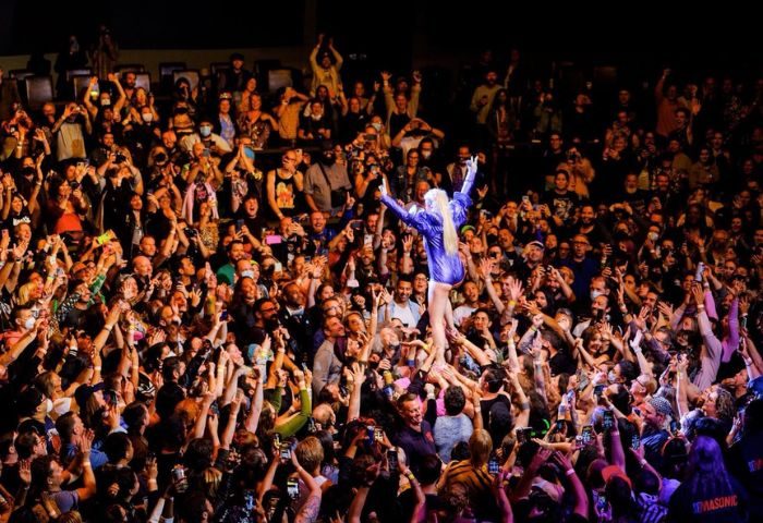 Peaches in Toronto concert. Crowd surfing at a Peaches concert in Toronto. Gay travel guide. Toronto travel advice.